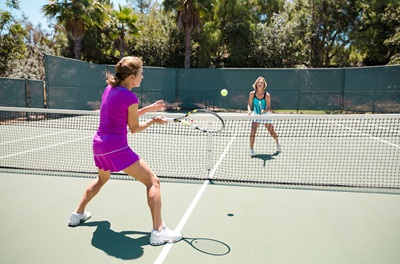 Two senior women playing tennis